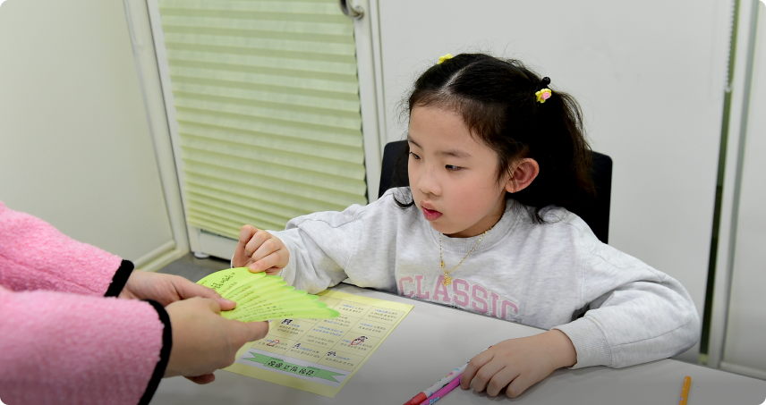 참가자 어린이가 동화 속 주인공에게 해주고 싶은 말을 신중하게 고르고 있다.